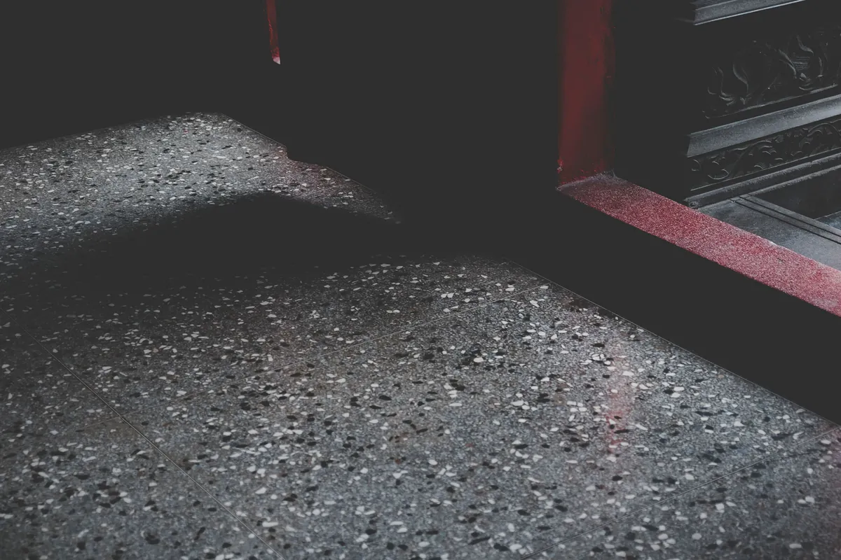 Close-up of a dark multi-tone flake-textured floor