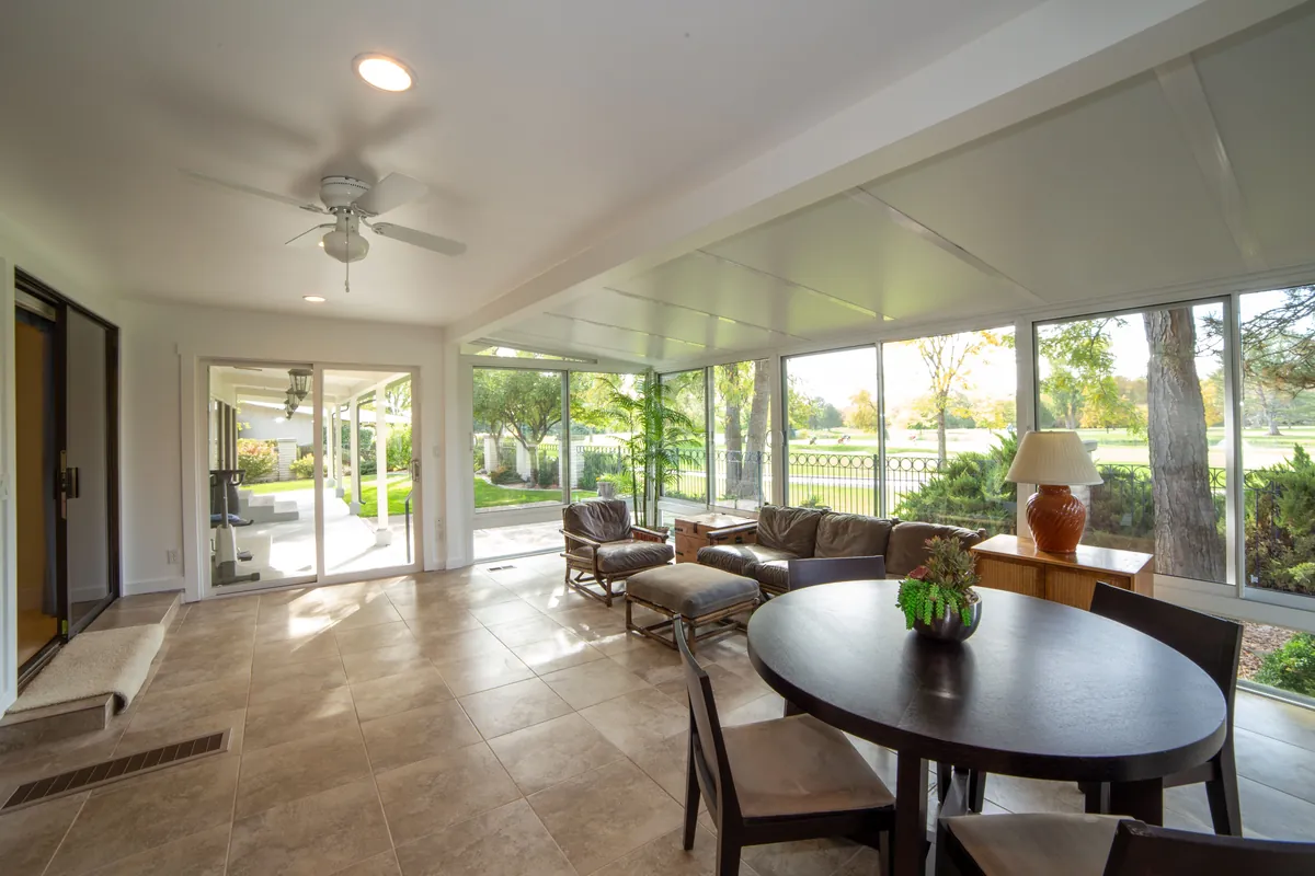 Enclosed Florida lanai with a wide backyard view