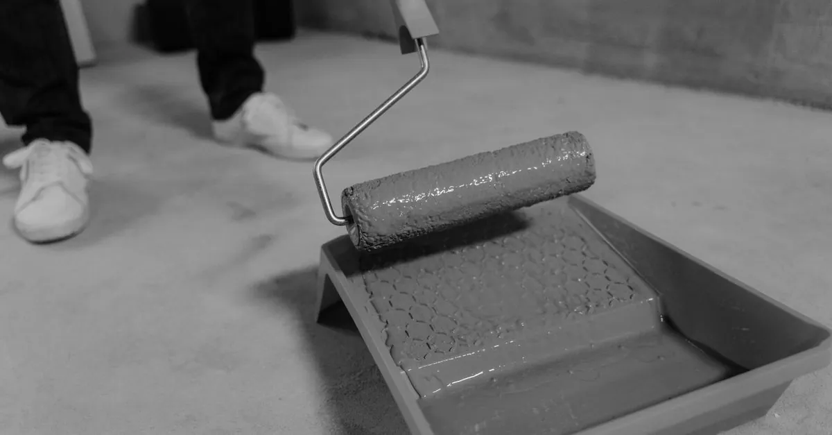 Roller and tray of floor primer on a bare concrete slab